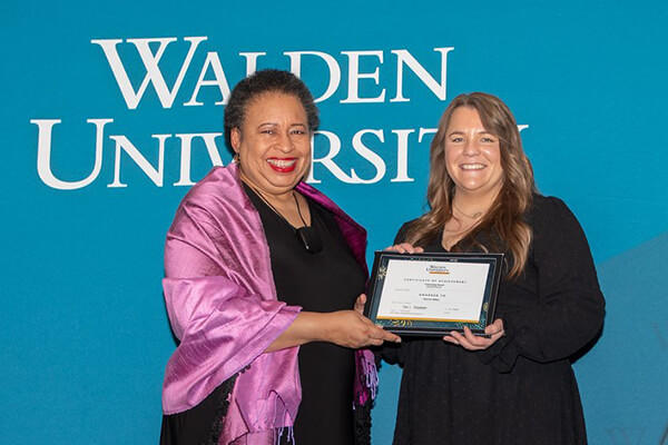 Darrian Pelkey (right) receives Walden’s Citizenship Award from Board of Directors Chair Toni Freeman. 