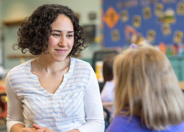 Early childhood educator with a student.